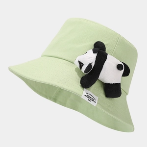 Detail view of light green cotton bucket hat featuring a 3D plush panda and white woven label