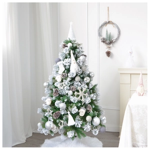 Lush snow-flocked Christmas tree with silver ornaments and cozy white fur tree skirt