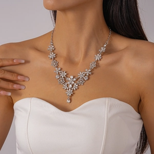 Detail of luxury silver flower pendant necklace with sparkling crystals on model