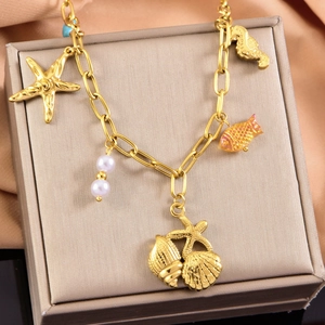 Gold ocean themed necklace with starfish, shell and seahorse charms in a jewelry box