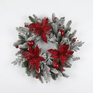 Christmas wreath with velvet poinsettia red berries and pine needles with snow effect