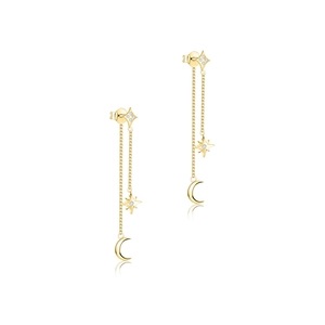 Macro detail of gold star and moon tassel earrings with sparkling zircon gemstones