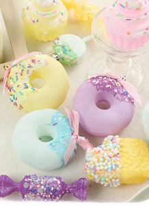 Detailed view of pastel macaron-colored donut and cupcake Christmas ornaments with glitter