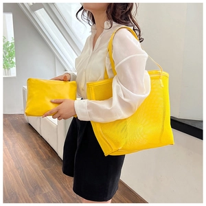 Detail shot of a yellow mesh tote bag with an inner pouch in a modern home setting