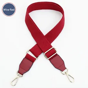 Adjustable burgundy canvas bag strap with gold metal hooks for crossbody purses
