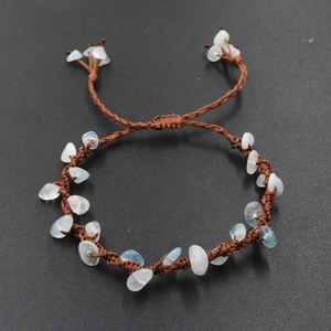 Handmade woven brown rope bracelet featuring light blue prehnite stones in a boho style