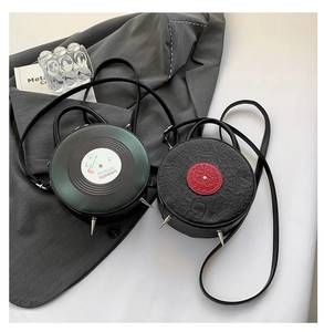 Detail view of round vinyl record bag and portrait relief crossbody with punk spikes