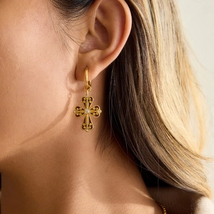 Vintage baroque gold cross earrings with crystals shown on model in close-up shot