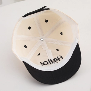Detail view of child baseball cap interior with mesh lining and adjustable strap