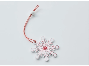 White wooden snowflake ornament with red stitch patterns and hanging bead details