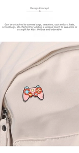 Pink game controller enamel pin displayed on a white canvas bag accessory