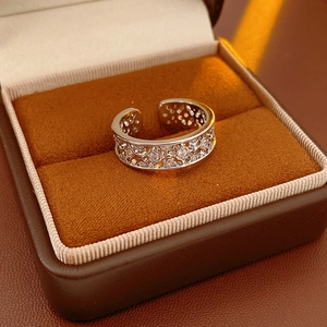 Macro shot of silver plated flower ring with cubic zirconia in a jewelry box