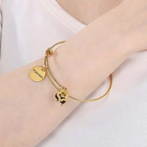 Detail of adjustable gold bangle with 'I love you mom' heart pendant and floral charm