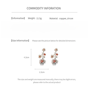 Detailed view of vintage rose earrings size 4.2cm by 1.5cm with copper and zircon specs