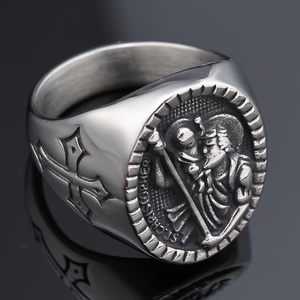 Macro detail of silver Anubis cross ring with St. Christopher relief and polished finish
