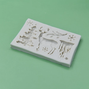 White silicone mold featuring Christmas tree, reindeer, and snowflakes for DIY baking