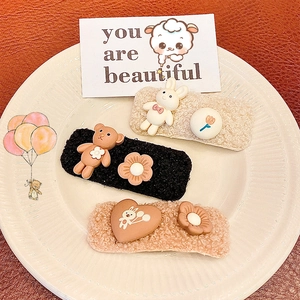 Cute plush hair clips set featuring cartoon bears and rabbits on a beige patterned plate