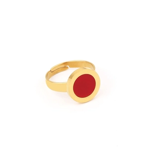 Macro view of a gold open ring featuring a smooth round red stone inlay on a white base