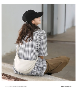 Minimalist white crescent nylon bag styled with casual black and white checkered shirt