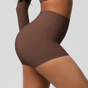 Close-up of high-waist yoga shorts in brown featuring peach lift and seamless fabric