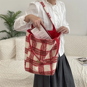 Macro detail of red plaid lamb wool tote bag featuring soft texture and spacious interior