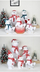 Christmas flocked white bear figurines with festive scarves in a cozy holiday setting
