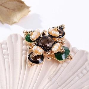 Baroque cross brooch with freshwater pearls and enamel inlay on a shell tray