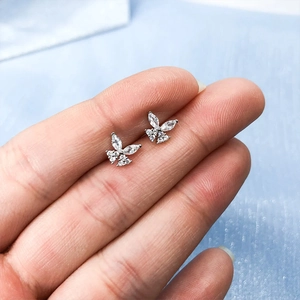 Detailed close-up of 925 sterling silver butterfly ear studs with sparkling cubic zirconia