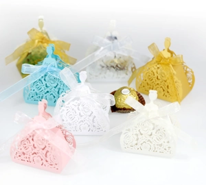 Detailed laser-cut princess dress favor boxes with satin bows in various pastel colors