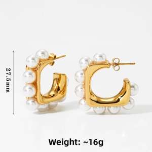Detail of C-shaped gold hoop earrings with shell pearls measuring 27.5mm and weighing 16g