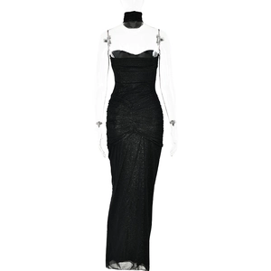 Detail of elegant black glitter evening gown featuring halter neckline and ruched waist
