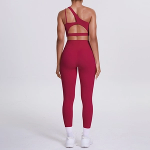 Detail view of the back of a burgundy one-shoulder sports bra and high waist leggings set
