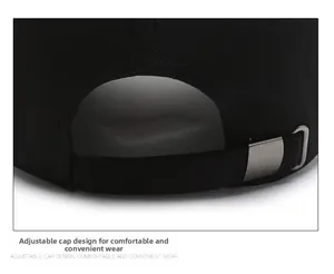 Detail of black cotton baseball cap showing adjustable strap and silver metal buckle