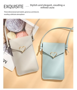 Detail of light gray and blue crossbody phone bags with heart shaped gold tone buckles