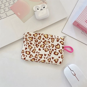 Detail of the heart leopard print fabric pouch with a pink lanyard and metal zipper