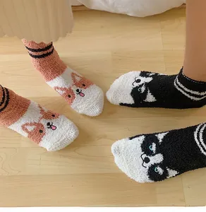 Detailed view of thick coral fleece socks with cute cartoon dog patterns and soft textures