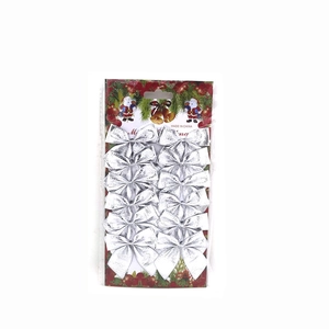 Detailed view of 12 silver glitter Christmas tree bows on blister card packaging