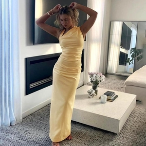 Detail view of ruched yellow one-shoulder maxi dress with silky slim-fit silhouette
