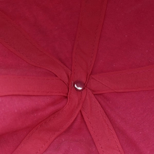 Detailed macro view of the interior seams and metal rivet of the pink washed cotton cap