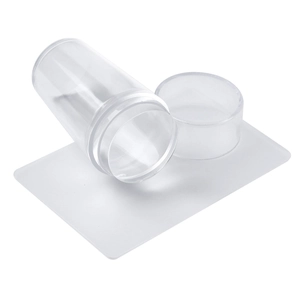 Clear nail art stamper set with scraper and protective cap on a white background