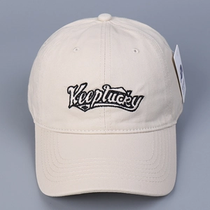 Minimalist beige cotton baseball cap with black Keeplucky embroidery and paper tag