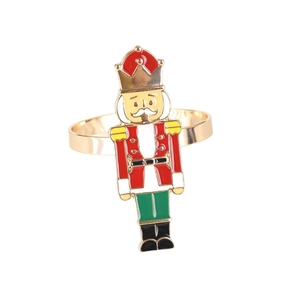 Nutcracker soldier napkin ring in gold finish with red and green enamel details
