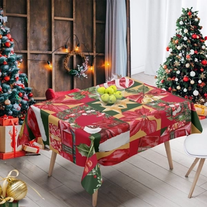 Detail of Christmas tablecloth with poinsettia and gift patterns on a wooden table