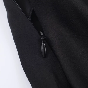 Detailed close-up of a high-quality invisible zipper on black twill fabric for women top