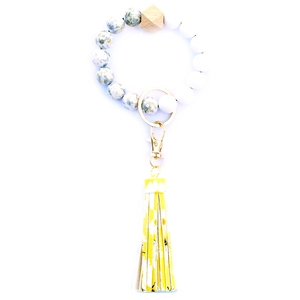 Beaded wristlet keychain with wooden bead, golden ring and yellow daisy print leather tassel