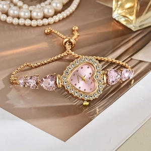 Elegant gold quartz bracelet watch with pink heart dial and sparkling rhinestone bezel