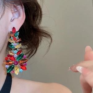 Macro detail of bohemian flower stud earrings with vibrant multi-colored crystal stones