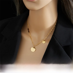 Close-up of gold stainless steel necklace with engraved Good Luck moon star pendants