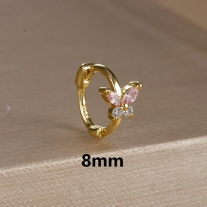Macro shot of 8mm gold butterfly huggie earring with pink and white zirconia stones