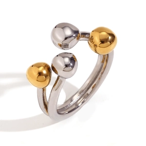 Two-tone stainless steel open ring with 18K gold and silver spheres on white background